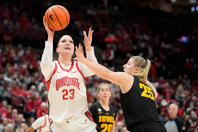 Jan 23, 2023; Columbus, OH, USA;  Ohio State Buckeyes forward Rebeka Mikulasikova (23) shoots over Iowa Hawkeyes forward Monika Czinano (25) and draws the foul during the first half of the NCAA women's basketball game at Value City Arena. Mandatory Credit: Adam Cairns-The Columbus Dispatch