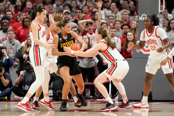Jan 23, 2023; Columbus, OH, USA;  Ohio State Buckeyes guard Taylor Mikesell (24) and guard Emma Shumate (5) defend Iowa Hawkeyes guard Gabbie Marshall (24) during the second half of the NCAA women's basketball game at Value City Arena. Ohio State lost 83-72. Mandatory Credit: Adam Cairns-The Columbus Dispatch