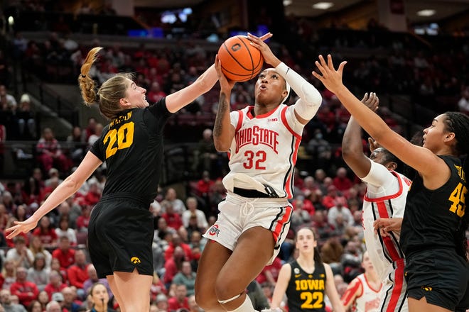 Jan 23, 2023; Columbus, OH, USA;  Ohio State Buckeyes forward Cotie McMahon (32) goes up for a layup past Iowa Hawkeyes guard Kate Martin (20) during the second half of the NCAA women's basketball game at Value City Arena. Ohio State lost 83-72. Mandatory Credit: Adam Cairns-The Columbus Dispatch