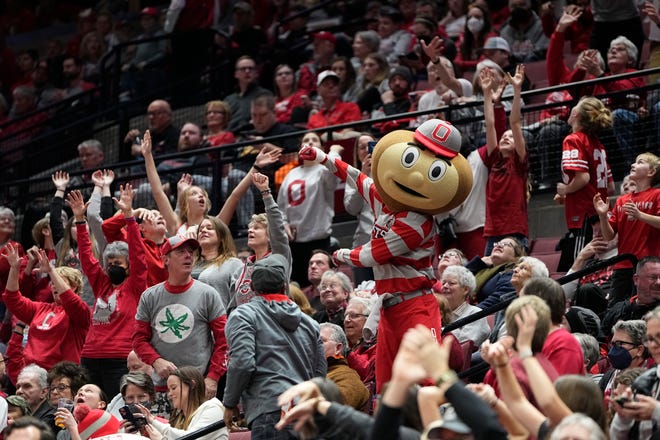 Jan 23, 2023; Columbus, OH, USA;  Brutus Buckeye reaches for a t-shirt during the second half of the NCAA women's basketball game between the Ohio State Buckeyes and the Iowa Hawkeyes at Value City Arena. Ohio State lost 83-72. Mandatory Credit: Adam Cairns-The Columbus Dispatch