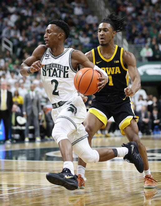 Michigan State guard Tyson Walker drives by Iowa guard Ahron Ulis during the second half of MSU's 63-61 win on Thursday, Jan. 26, 2023, at Breslin Center.