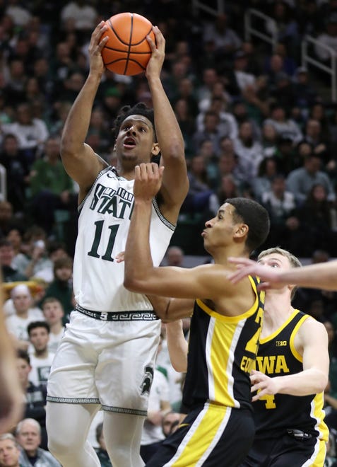 Michigan State Spartans guard A.J. Hoggard (11) scores against Iowa Hawkeyes forward Kris Murray (24) during first half action Thursday, January 26, 2023.