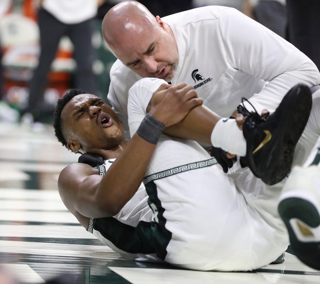 Michigan State guard Tyson Walker reacts after twisting his ankle against Iowa during the second half of MSU's 63-61 win on Thursday, Jan. 26, 2023, at Breslin Center.