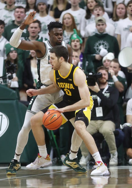 Michigan State Spartans center Mady Sissoko (22) defends against Iowa Hawkeyes forward Filip Rebraca (0) during first half action Thursday, January 26, 2023.