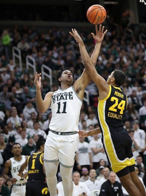 Michigan State guard A.J. Hoggard shoots against Iowa forward Kris Murray during the second half of MSU's 63-61 win on Thursday, Jan. 26, 2023, at Breslin Center.