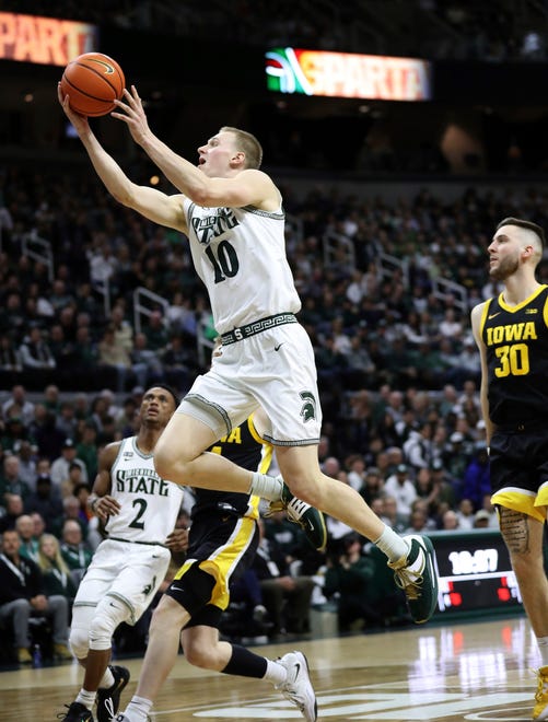 Michigan State forward Joey Hauser scores against Iowa guard Connor McCaffery during the first half of MSU's 63-61 win on Thursday, Jan. 26, 2023, at Breslin Center.