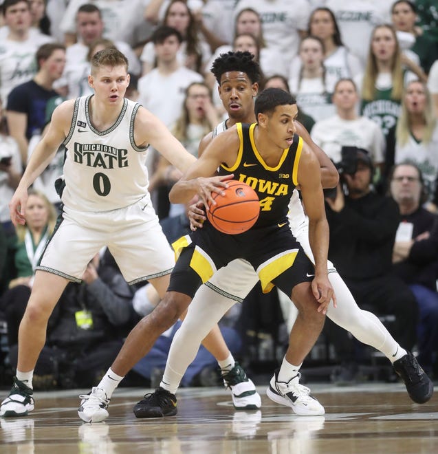Michigan State Spartans guard A.J. Hoggard (11) defends against Iowa Hawkeyes forward Kris Murray (24) during first half action Thursday, January 26, 2023.