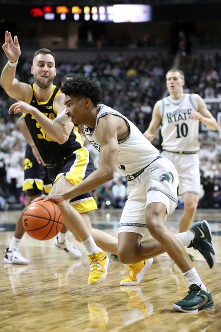 Michigan State Spartans guard Jaden Akins (3) drives against Iowa Hawkeyes guard Connor McCaffery (30) during first half action Thursday, January 26, 2023.