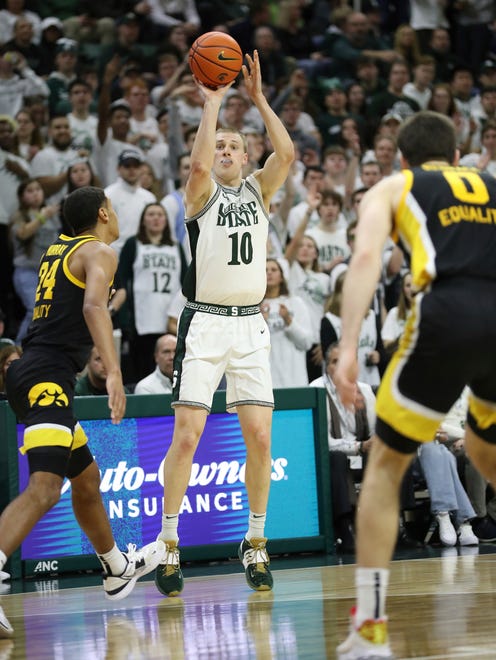 Michigan State forward Joey Hauser hits a 3-pointer against Iowa forward Kris Murray, left, during the second half of MSU's 63-61 win Thursday, Jan. 26, 2023, at Breslin Center.