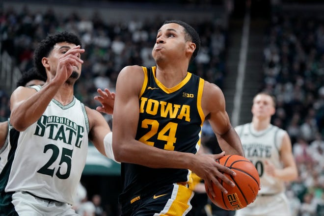 Iowa forward Kris Murray (24) attempts a layup as Michigan State forward Malik Hall (25) defends during the first half of an NCAA college basketball game, Thursday, Jan. 26, 2023, in East Lansing, Mich. (AP Photo/Carlos Osorio)
