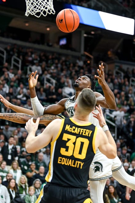 Michigan State's Mady Sissoko, back, and Iowa's Connor McCaffery go after a rebound during the first half on Thursday, Jan. 26, 2023, at the Breslin Center in Lansing.

230126 Msu Iowa Bball 006a