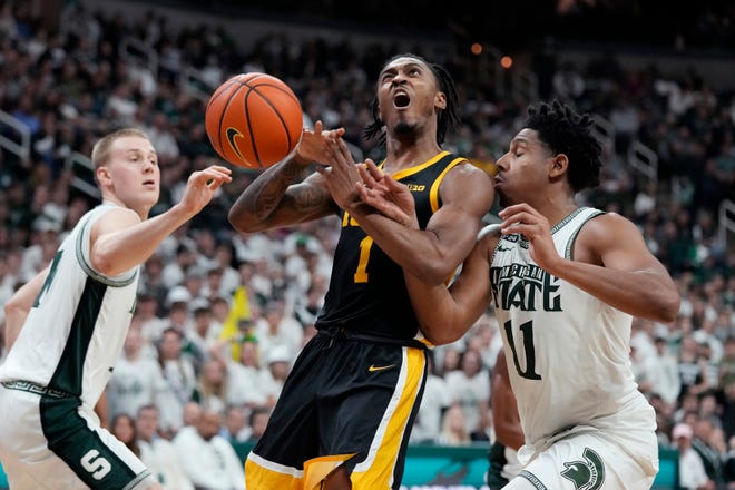 Iowa guard Ahron Ulis (1) loses control of the ball as Michigan State guard A.J. Hoggard (11) defends during the first half of an NCAA college basketball game, Thursday, Jan. 26, 2023, in East Lansing, Mich. (AP Photo/Carlos Osorio)