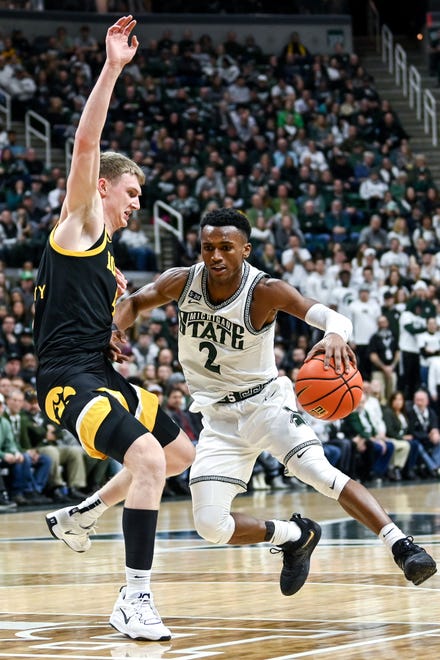 Michigan State's Tyson Walker, right, moves the ball as Iowa's Josh Dix defends during the first half on Thursday, Jan. 26, 2023, at the Breslin Center in Lansing.