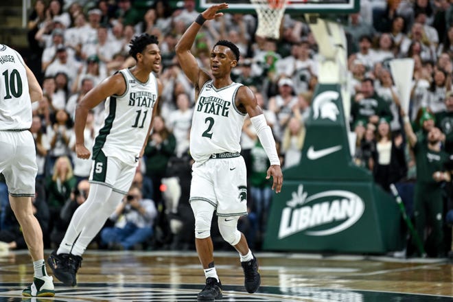 Michigan State's Tyson Walker, center, celebrates after Malik Hall's dunk against Iowa during the first half on Thursday, Jan. 26, 2023, at the Breslin Center in Lansing.