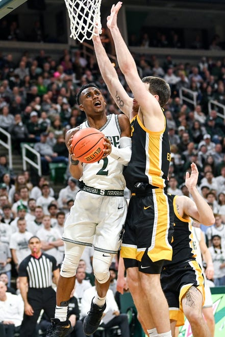 Michigan State's Tyson Walker, left, shoots as Iowa's Lorne Bowman II defends during the second half on Thursday, Jan. 26, 2023, at the Breslin Center in Lansing.