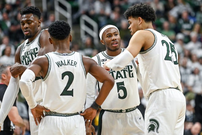 Michigan State's Malik Hall, right, talks with Tre Holloman, center, during the second half in the game against Iowa on Thursday, Jan. 26, 2023, at the Breslin Center in Lansing.