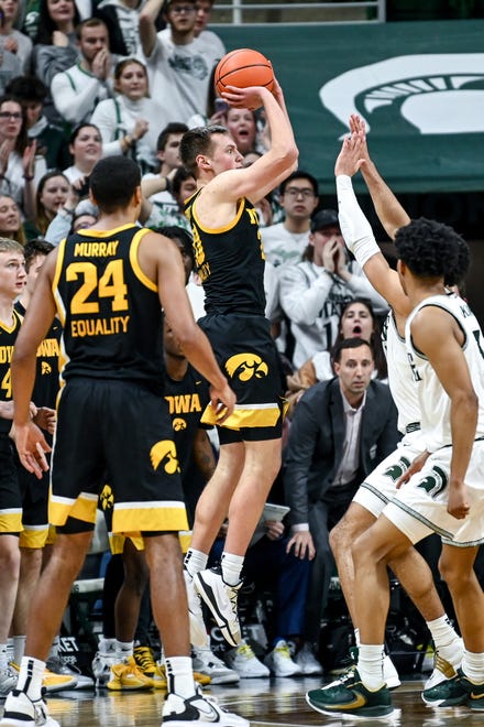 Iowa's Payton Sandfort, left, shoots and misses a 3-pointer with seconds left in the game against Michigan State on Thursday, Jan. 26, 2023, at the Breslin Center in Lansing.