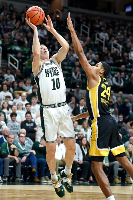 Michigan State's Joey Hauser, left, shoots as Iowa's Kris Murray defends during the first half on Thursday, Jan. 26, 2023, at the Breslin Center in Lansing.