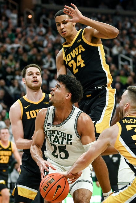 Michigan State's Malik Hall, center, looks to shoot as Iowa's defense closes in during the second half on Thursday, Jan. 26, 2023, at the Breslin Center in Lansing.