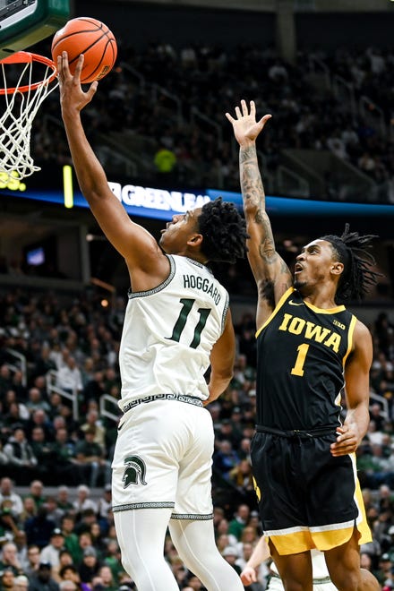 Michigan State's A.J. Hoggard scores as Iowa's Ahron Ulis defends during the first half on Thursday, Jan. 26, 2023, at the Breslin Center in Lansing.