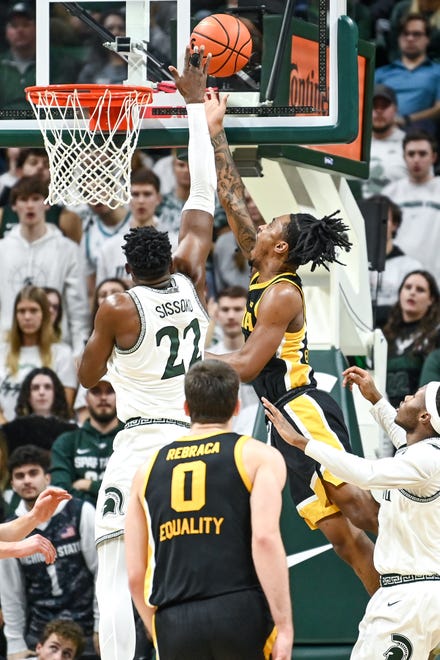 Michigan State's Mady Sissoko, left, defends as Iowa's Ahron Ulis shoots during the second half on Thursday, Jan. 26, 2023, at the Breslin Center in Lansing.
