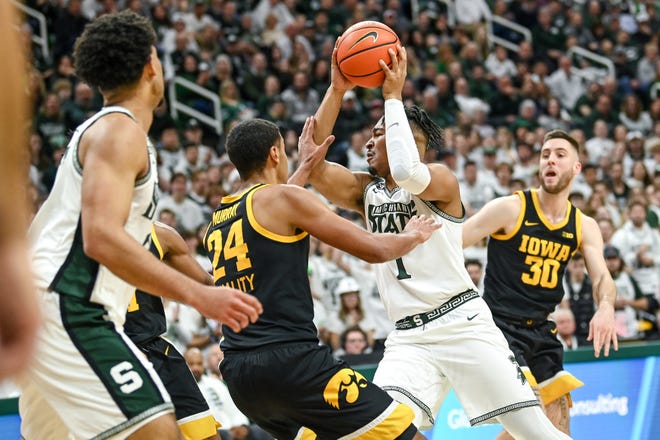 Michigan State's Pierre Brooks, right, passes the ball past Iowa's Kris Murray for an assist to Mady Sissoko during the second half on Thursday, Jan. 26, 2023, at the Breslin Center in Lansing.