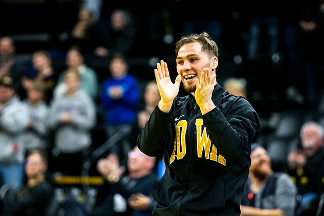 Iowa's Spencer Lee cheers on teammates as they are acknowledged on senior day after a NCAA college men's wrestling dual against Oklahoma State, Sunday, Feb. 19, 2023, at Carver-Hawkeye Arena in Iowa City, Iowa.